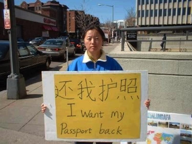 A Falun Gong practitioner across the street from the Chinese Consulate in Washington, D.C., holds a sign that says: 'I want my Passport back!'  (The Epoch Times photo archive)