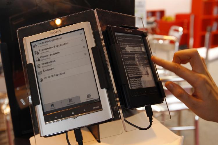 E-BOOKS: A person tests an e-book reader during the 31st Paris book fair on March 18 in Paris. E-books sales have now exceeded paperbacks in the U.S.