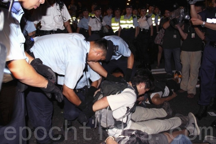 Riot police handcuff a demonstrator after the July 1, 2011 protest march in Hong Kong. (Cai Wenwen/The Epoch Times)