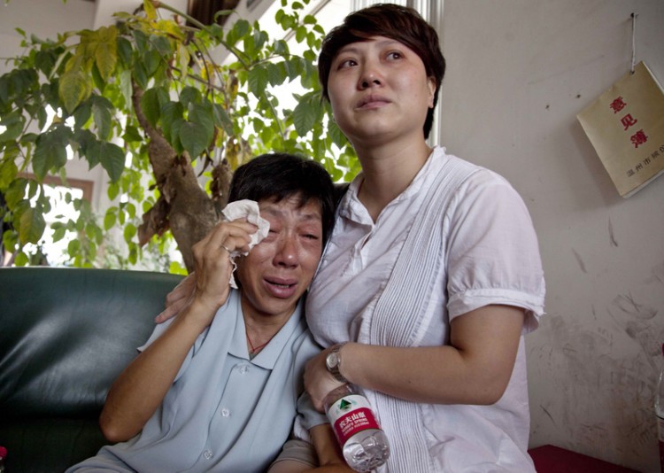 Family members grieve after identifying a loved one's body. (STR/AFP Getty Images)