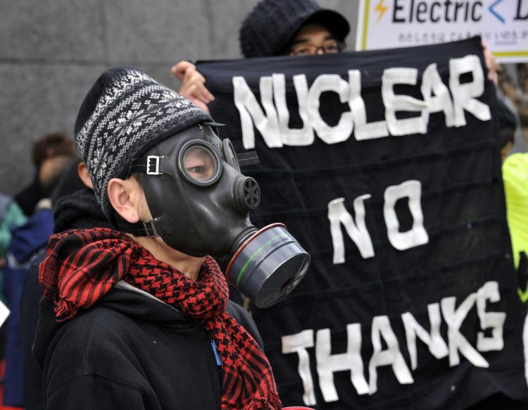A protester wears a gas mask to protest against nuclear plants in front of the Tokyo Electric Power Co. headquarters in Tokyo on March 27. In light of the nuclear crisis continues in Japan, Physicians for Global Survival are calling for a moratorium on new nuclear reactors in Canada and a suspension of operations at existing reactors on fault lines. (Yoshikazu Tsuno/AFP/Getty Images)
