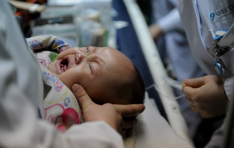 A newly born Chinese who may be spared the fate of becoming human traffic. (STR/AFP/Getty Images)