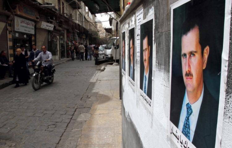 Posters of Syrian President Bashar al-Assad decorate a street as Syrians walk in the old city of Damascus on April 2, 2011. (Anwar Amro/AFP/Getty Images)