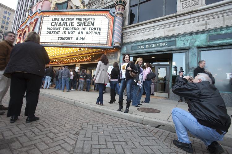 Charlie Sheen fans pose for pictures in front of the Fox Theatre in Detroit, Michigan on April 2, to start his show 'Violent Torpedo of Truth/Defeat is Not an Option,' which which saw Sheen walk off the stage during his performance.   (Geoff Robins/Getty Images )