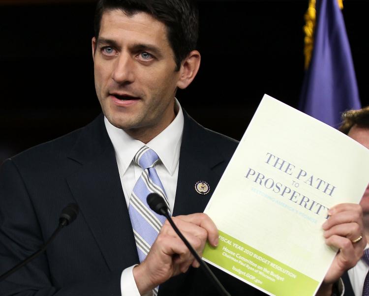 ON THE TABLE: U.S. Rep. Paul Ryan (R-Wis.), chairman of the House Budget Committee, holds up a copy of the 2012 Republican budget proposal during a news conference April 5, 2011 on Capitol Hill in Washington. (Alex Wong/Getty Images)