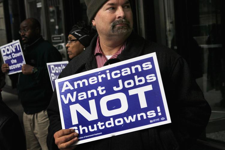 SHUTDOWN WORRIES: Federal Employees demonstrate on April 7 outside the Ralph H. Metcalfe Federal Building in Chicago, Ill. If a deal is not reached on the federal budget before midnight on Friday non-essential government services are expected to be shutdown. (Scott Olson/Getty Images )