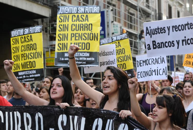Young people hold placards reading 'Without a house, without a job, without pension' during a demonstration to protest against insecurity against high unemployment, job insecurity and government spending cuts, responding to an initiative launched on the Internet, in Spain on April 7.  (Dominique Faget/Getty Images)