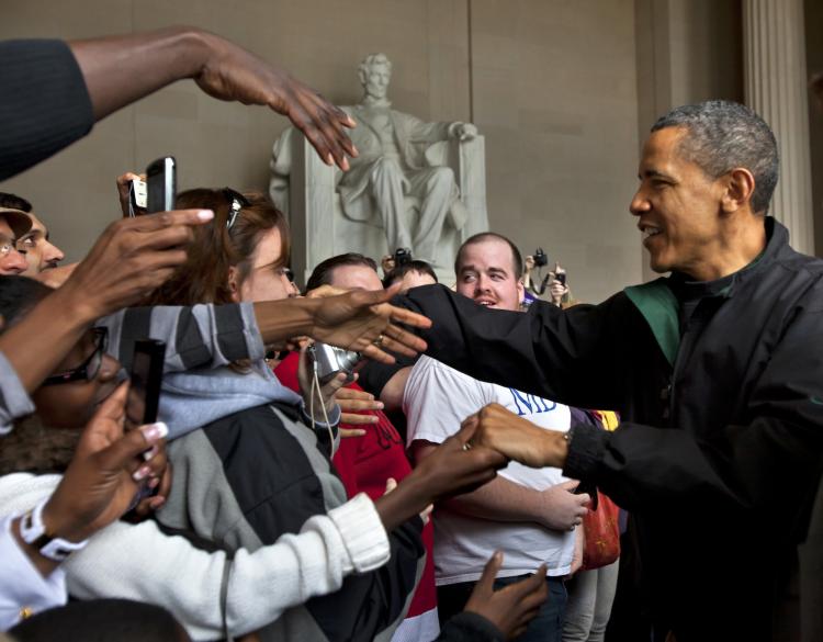 President Obama shakes the hands of tourists visiting the Lincoln Memorial during a surprise visit a day after budget negotiations with Congress prevented a government shutdown April 9,  in Washington, DC.  (Jim Lo Scalzo-Pool/Getty Images)