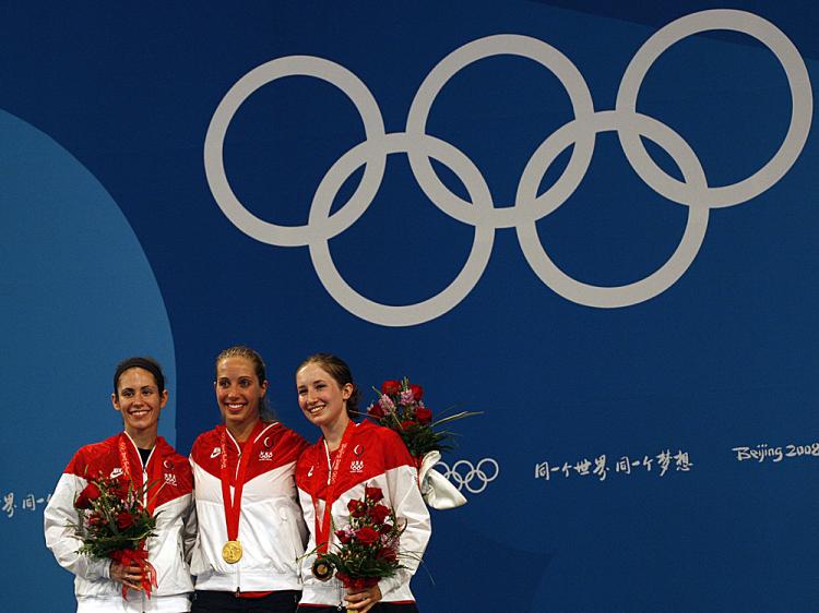 Mariel Zagunis of the USA (C) celebrates next to her compatriots Sada Jacobson (L) and Angelica Ward on the podium of the women's individual sabre on August 9, 2008 at the Fencing Hall of National Convention Center Adrian Dennis/AFP/Getty Images ()