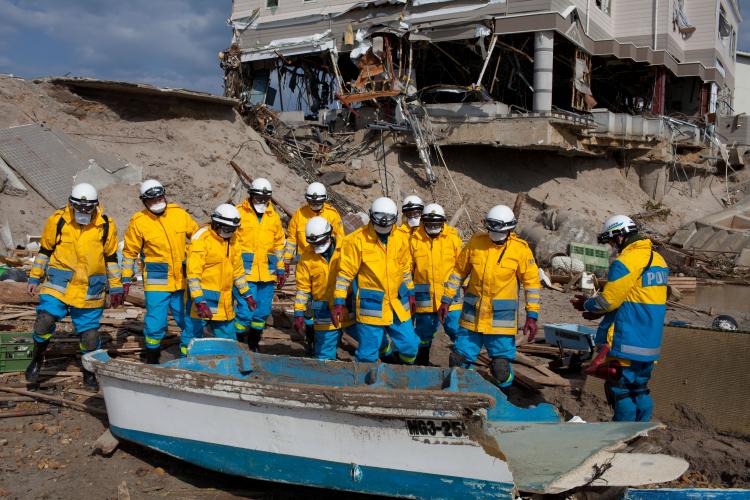 Japanese police officers check a wrecked boat as they search for tsunami victims in Minamisanriku, Miyagi prefecture on April 12.  (Yasuyoshi Chiba/Getty Images )