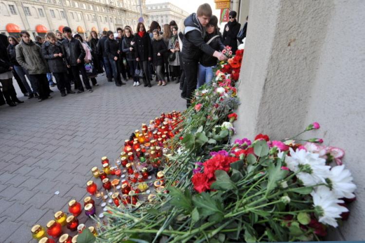 People lay flowers and place candles outside a metro station hit by a blast in downtown Minsk, on April 12, 2011. (Viktor Drachev/AFP/Getty Images)