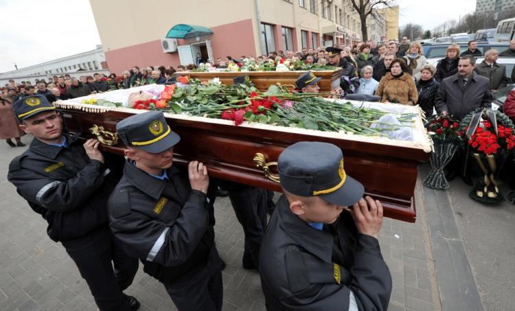 Belarussian policemen carry the coffins of Galina Pikulik (background) and Anatoliy Narkevich, victims of the Minsk metro bombing that killed 12 and wounded 200 on April 11, during a funeral ceremony on April 13, 2011.  (Viktor Drachev/AFP/Getty Images)
