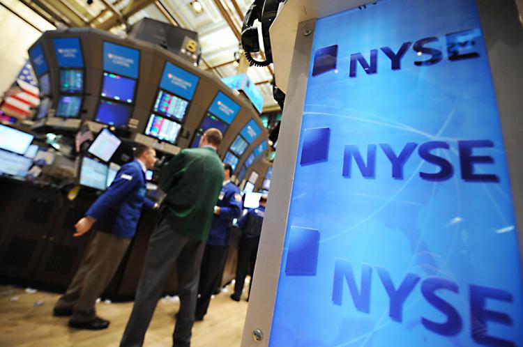 STOCKS JUMP: Workers are seen on the floor of the New York Stock Exchange Wednesday April 20. U.S. markets gained across the board as corporate earnings propelled stocks higher. (Stan Honda/AFP/Getty Images)