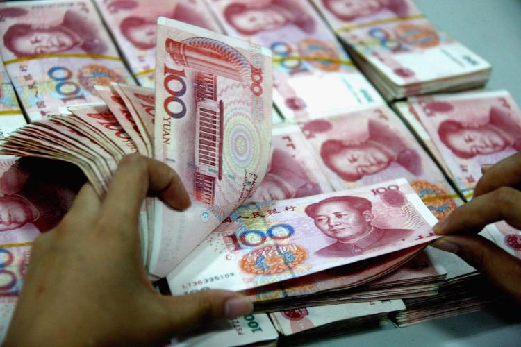 A staff member counts money at a branch of Industrial and Commercial Bank of China Limited (ICBC) on April 18 in Huaibei, Anhui Province of China. The People's Bank of China (PBOC), the central bank, raised the required reserve ratio of the country's lenders by 50 basis points from April 21 for the fourth time this year to curb stubbornly high inflation. (ChinaFotoPress/Getty Images)