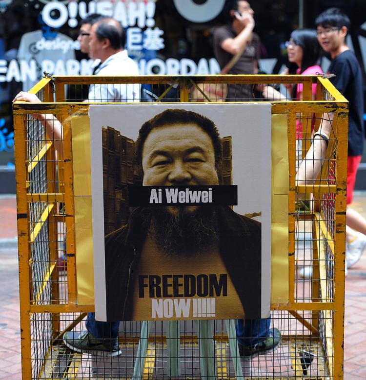 A man sits in 'jail' as a group of human rights advocates hold a protest at a busy shopping area asking for the release of mainland artist Ai Weiwei in Hong Kong on April 22, 2011.  (Mike Clarke/Getty Images)