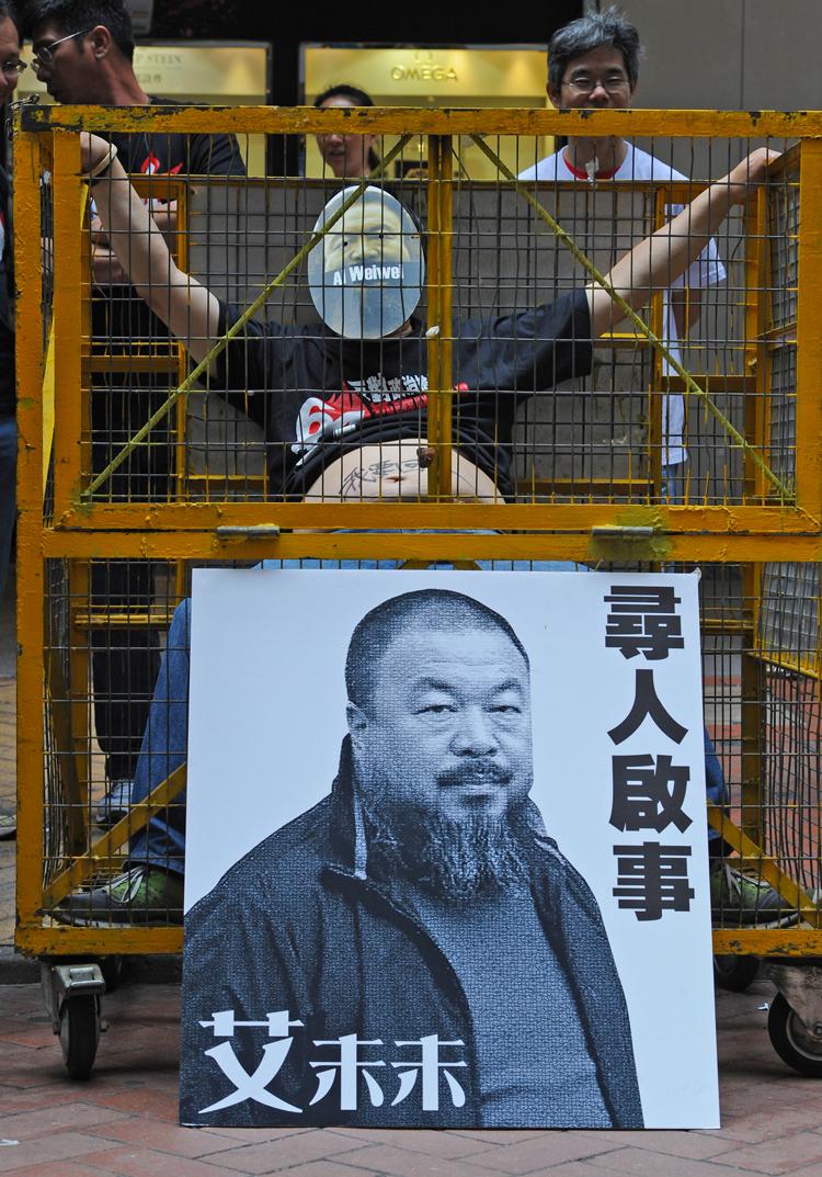 'HETEROGENEOUS THINKING': An individual in Hong Kong sits in 'jail' as a group of human rights advocates hold a protest at a busy shopping area, asking for the release of mainland artist Ai Weiwei in Hong Kong on April 22. The artist has not been seen sin (Mike Clarke/AFP/Getty Images)