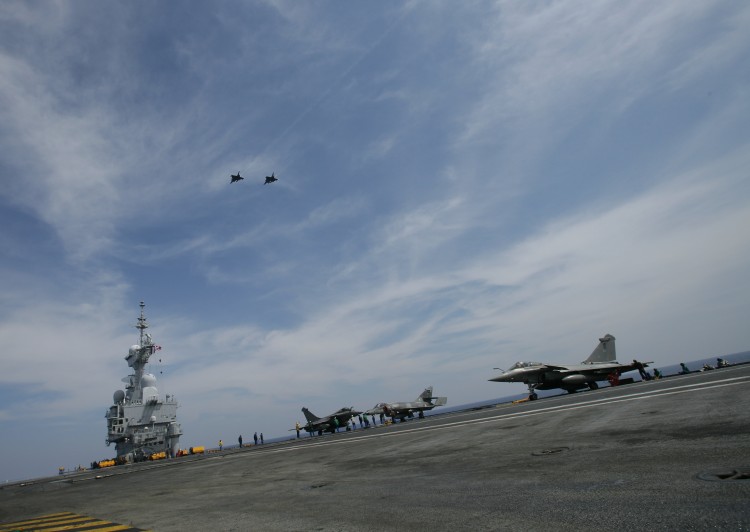 Two French Navy Rafale jet fighters fly above the Charles de Gaulle aircraft carrier on the final part of their landing, on April 21, 2011 in the Mediteranean sea. (Alexander Klein/AFP/Getty Images)