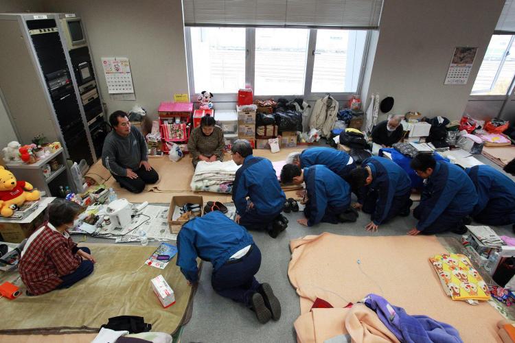 Tokyo Electric Power Co. President Masataka Shimizu (C) and company executives bow to evacuees to apologize for the accident at their company's Fukushima Daiichi nuclear power plant at a shelter at Koriyama in Fukushima prefecture on April 22. (STR/AFP/Getty Images)