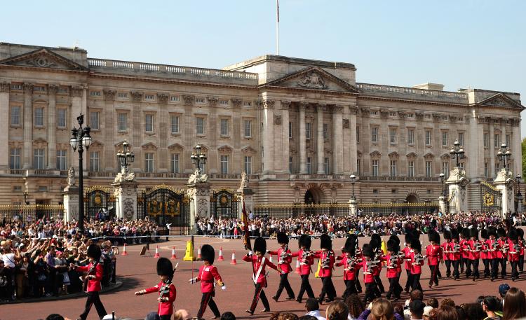 Tourists watch the daily ceremony of the Changing of the Guard outside Buckingham Palace on April 22. Fountains have been cleaned, lawns trimmed, and giant Union Jack flags are flying as London puts on its best face for Prince William and Kate Middleton's wedding on April 29. Hundreds of thousands of well-wishers are expected in addition to the hundreds of VIPs invited to attend the ceremony at Westminster Abbey. (Carl De Souza/AFP/Getty Images)