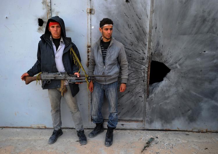 THE NEXT MOVE: Libyan rebels stand close to a building where forces loyal to leader Moammar Gadhafi are suspected to be held up in the Zwabi District of the city of Misrata on April 24.  (Christophe Simon/Getty Images )