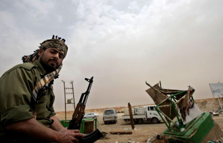 A Libyan rebel guards a post at the battle front of the strategic town of Ajdabiya on April 25, 2011.  (Marwan Naamani/AFP/Getty Images)