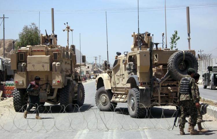 Afghan soldiers secure the road outside Kandahar Prison following the mass escape by inmates, on April 25, 2011 in Kandahar, Afghanistan. Over 450 prisoners, mostly Taliban fighters, escaped after insurgents dug a 350 metre long tunnel into the main jail. (Getty Images)