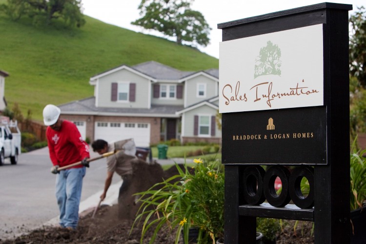 GROWTH TREND MIXED: Workers work on landscaping in front of model homes on display at the Oakbridge housing development in Danville, California. Groundbreaking for single-family homes rose 9.4 percent, but construction of large apartment units surged by 31.8 percent, reflecting a growing trend of Americans shunning home ownership.(David Paul Morris/Getty Images)