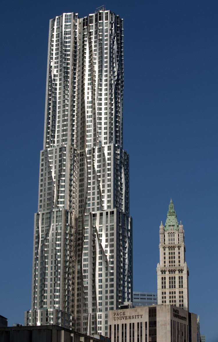 TOWERING OVER DOWNTOWN: New York by Gehry at 8 Spruce St., a recently opened skyscraper, is seen in front of the iconic Woolworth Building, on March 2. The 76-story modern tower is the tallest residential building in the Western Hemisphere. (Don Emmert/AFP/Getty Images)