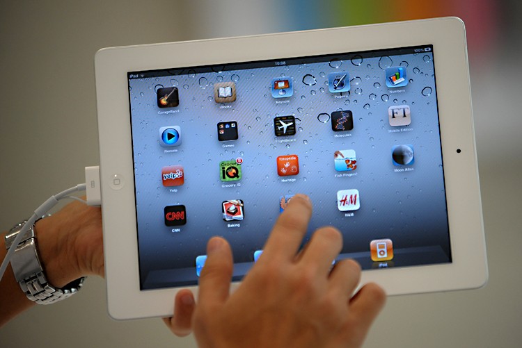 DISRUPTION: A man navigates through the new iPad 2 during its launch in the Philippines at an Apple store in Manila on April 29. A Foxconn factory in central China, where the iPad 2 is currently being manufactured, was the site of an explosion last week. (Noel Celis/AFP/Getty Images)