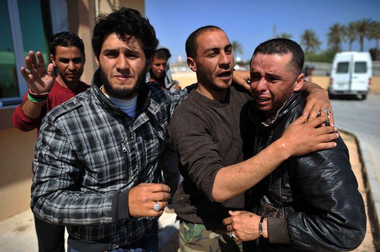 Libyan rebels weep after a comrade was shot in the head at a hospital in Misrata on April 29. (Christophe Simon/AFP/Getty Images)