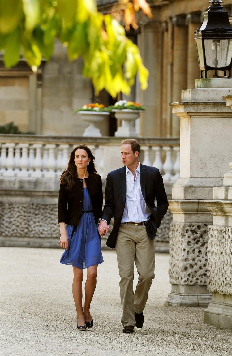 Prince William and his wife Kate, the Duchess of Cambridge, walk hand in hand from Buckingham Palace in London, before departing by helicopter on April 30. (John Stillwell/AFP/Getty Images)