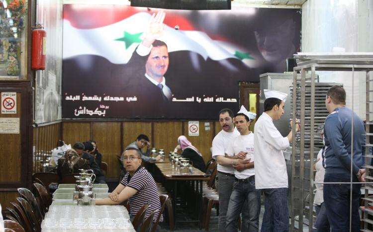 A large poster of Syrian President Bashar al-Assad adorns a wall at a restaurant in the capital Damascus on April 30, 2011. (Louai Beshara/AFP/Getty Images)