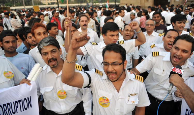 Striking pilots representing the Indian Commercial Pilots Association (ICPA) shout anti-corruption slogans during a protest to support social activist Anna Hazare in Mumbai on May 1. Flagship carrier Air India's woes deepened as a pilots' strike continued into its fifth day on May 1. (Sajjad Hussain/Getty Images)