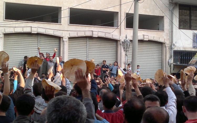 Syrian anti-government protesters hold up loaves of bread as they protest in the northern Syrian port and oil terminal of Banias, on May 3, 2011.  (AFP/Getty Images)
