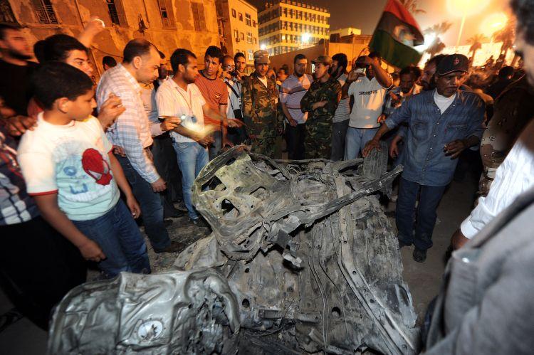 Libyan rebels gather around the remains of car which exploded near the headquarters of Libya's rebels in their eastern bastion of Benghazi late on May 3. The number of deaths in February alone in the war-torn country was 500-700. (Saeed Khan/AFP/Getty Images)
