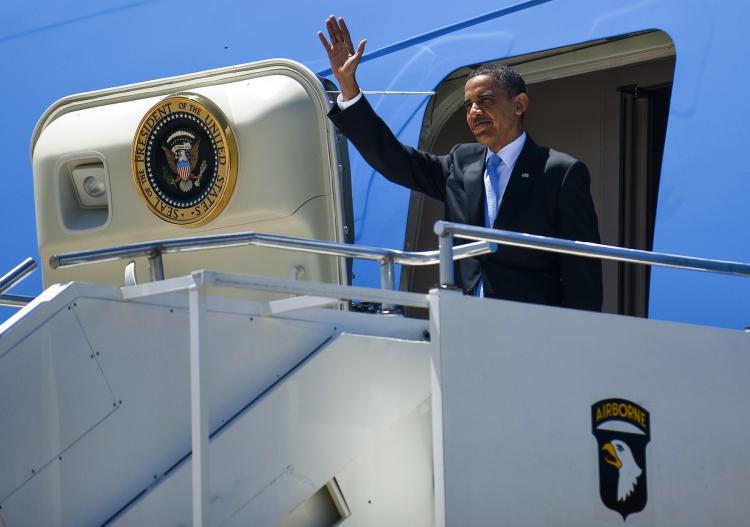 President Obama waves as he walks off Air Force One at Fort Campbell, Kentucky, May 6. On Wednesday due to bad weather, Air Force One made an aborted landing attempt with Obama aboard at the Bradley International Airport in Connecticut.  (Jim Watson/Getty Images )