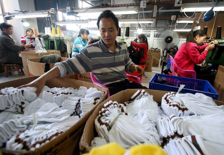 Laborers working at a sock factory in Jinjiang, in southeast China's Fujian province, on May 9. China's clothing industry was hit hard by the slump in the global economy.  (STR/AFP/Getty)