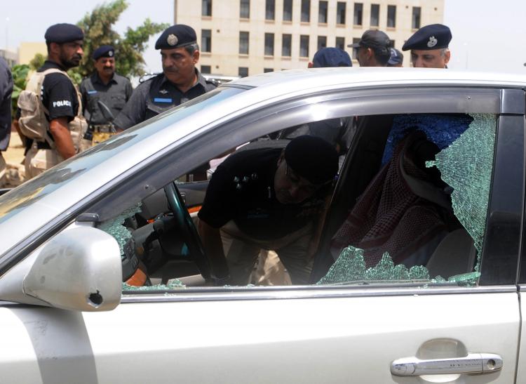Pakistani police officials inspect the bullet-riddled vehicle of a Saudi diplomat after a deadly attack in Karachi on May 16.  (Ritzwan Tabassum/Getty Images )