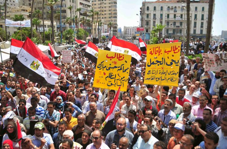 Egyptians hold banners calling for the trial of ousted president Hosni Mubarak and members of his former regime during a demonstration in the coastal city of Alexandria on May 20. (-/AFP/Getty Images)