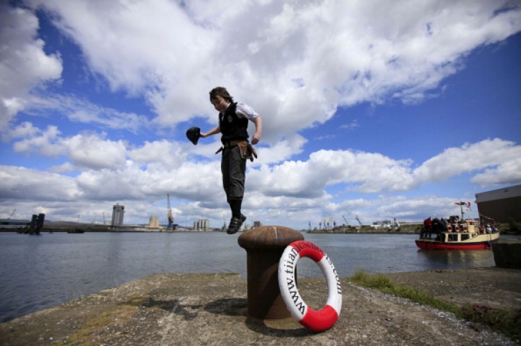 Carl Grant, 11, from Belfast, jumps off a dock cleat as people gather to attend a ceremony to mark the 100th anniversary of the launch of the ship, the 'Titanic,' in Belfast, Northern Ireland, on May 31, 2011. (Peter Muhly/AFP/Getty Images)
