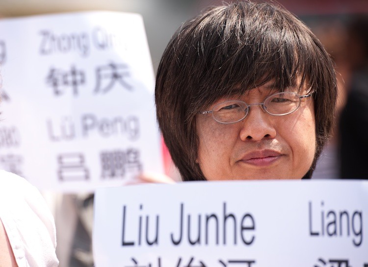 Tiananmen Square massacre survivor Shao Jiang holds a sign as a group gathers in central London on June 4, to mark the 22nd anniversary of the Tiananmen Square massacre in China in 1989. The group displayed the names of the 185 identified as being killed on the day as well as the names of those still being held in Chinese prisons for their part in the protests. (Leon Neal/AFP/Getty Images)