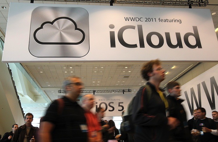 Attendees walk by a sign for the new iCloud during the 2011 Apple World Wide Developers Conference at the Moscone Center on June 6, in San Francisco, California. (Justin Sullivan/Getty Images)