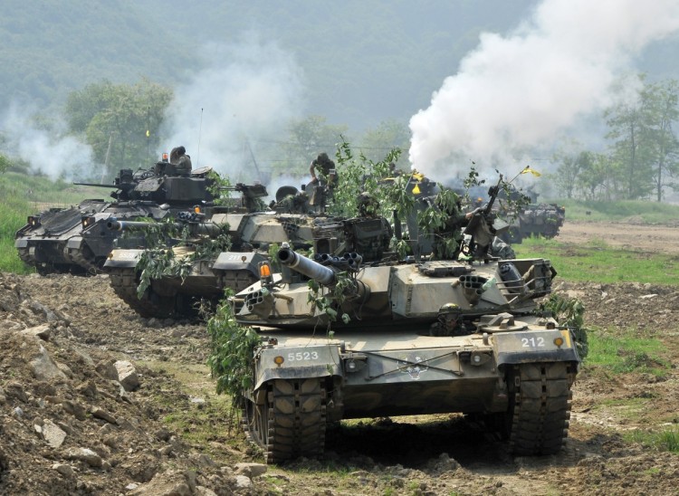 South Korea's K1 tanks (C) and an armored vehicle (L-back) participate in a joint military drill between South Korea and the US in Paju near the inter-Korean border on June 8, 2011. (Jung Yeon-Je/AFP/Getty Images)