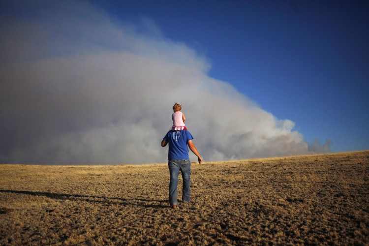 In this photo, a father holds his daughter to walk up a hill Springerville, Arizona. Father's Day gifts and cards have grown popular over the years. (Eric Thayer/Getty Images)