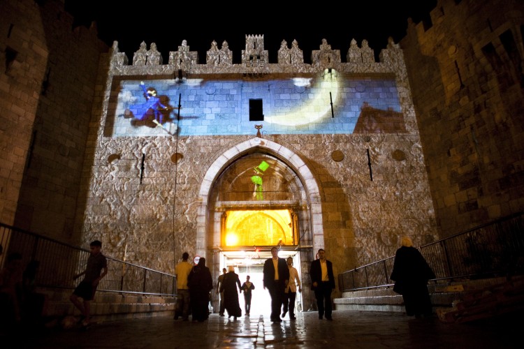 People walk throw the Damascus gate during the Jerusalem Festival of Lights on June 15, 2011 at Jerusalem's Old City, Israel. (Uriel Sinai/Getty Images)