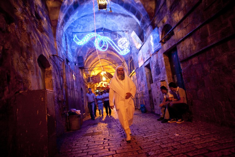 A Palestinian man walks towards the Damascus gate during the Jerusalem Festival of Lights on June 15, 2011 at Jerusalem's Old City, Israel. (Uriel Sinai/Getty Images)