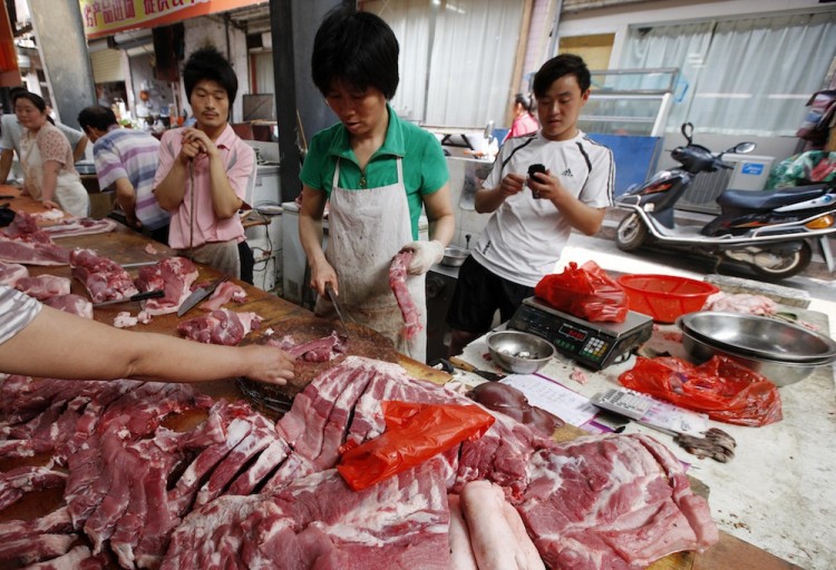A Chinese customer selects a piece of pork from a butcher stall at a market in Huaibei, east China's Anhui Province on June 20. Recently, a new chemical, phenylethanolamine A, has been found in pig feed in China, and a professor from a well-known university is implicated in the development and sale of 'lean meat powder.' (STR/AFP/Getty Images)