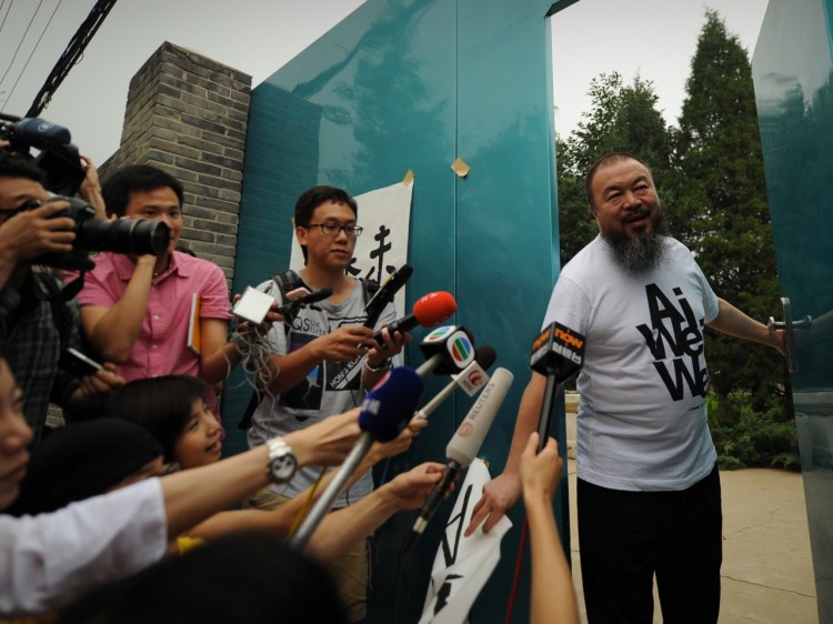 Outspoken Chinese artist Ai Weiwei arrives to speak to reporters outside his studio in Beijing on June 23. Weiwei has accepted a job to teach at the University of Berlin, but it's unclear whether he'll be allowed out of China. (Peter Parks/Getty Images)