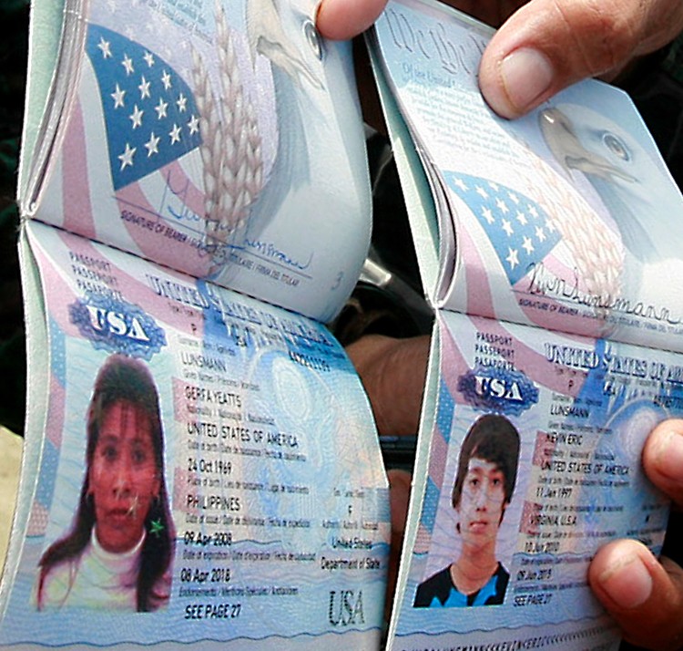 Police show passports of Gerfa Yeatts Lunsmann and her son, Kevin. (STR/AFP/Getty Images)