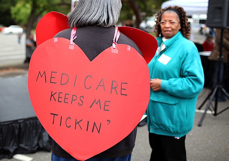ENTITLEMENTS: A senior citizen holds a sign during a rally to protect federal health programs at the 8th Annual Healthy Living Festival in Oakland, Calif., July 15. (Justin Sullivan/Getty Images)